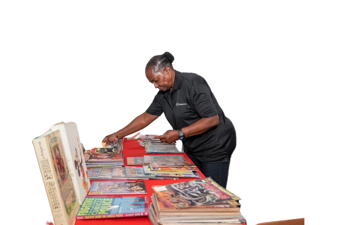 A Grasons employee sorting books and magazines in preparation for a sale.