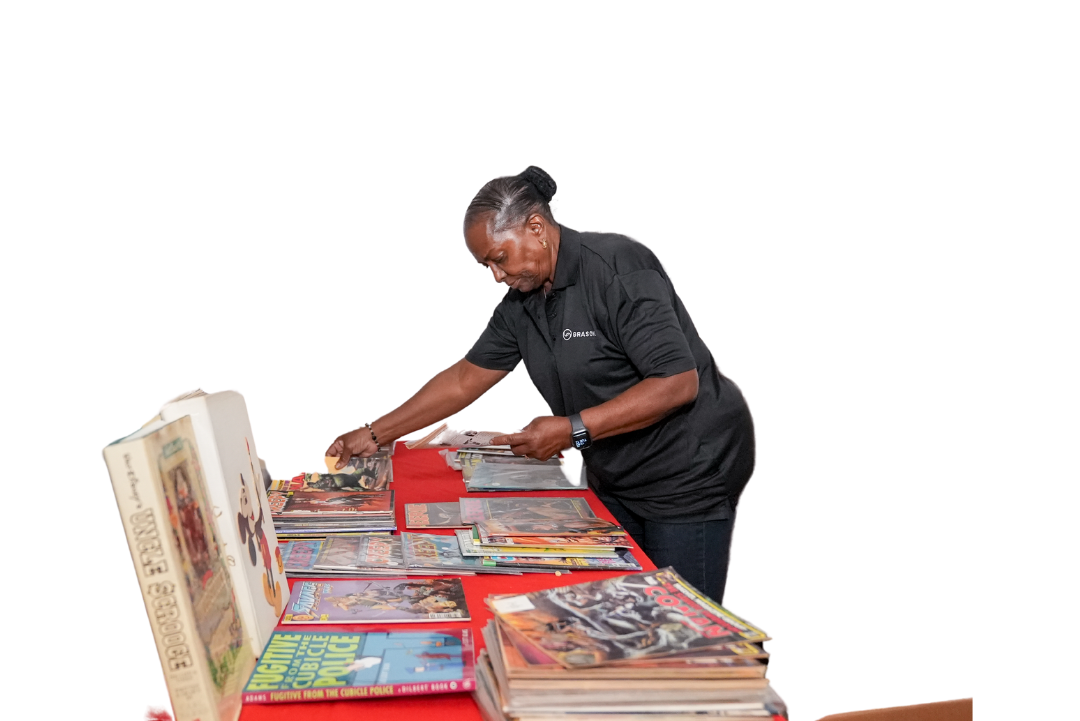 A Grasons employee sorting books and magazines in preparation for a sale.