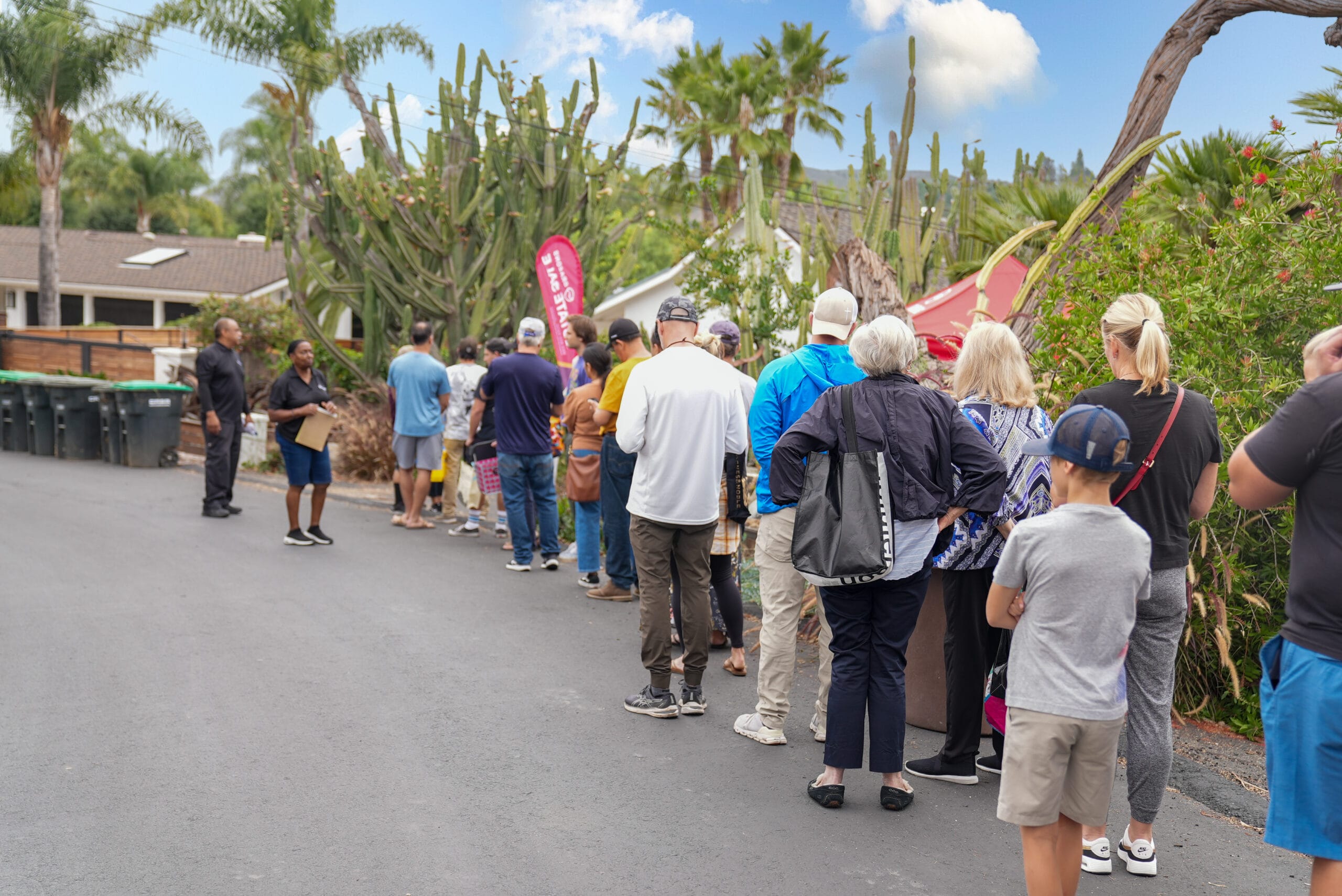 Group of people line up getting ready for an estate sale hosted by Grasons