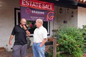 Grasons representative discussing with customer outside home