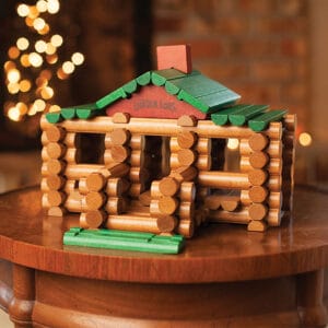 Vintage Lincoln Logs toy cabin house on a wooden table, a nostalgic find at a local estate sale